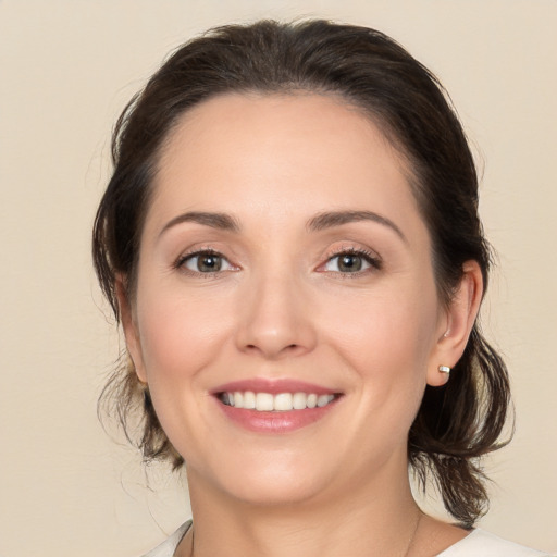 Joyful white young-adult female with medium  brown hair and brown eyes