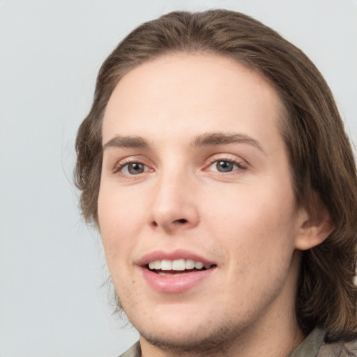 Joyful white young-adult male with medium  brown hair and brown eyes