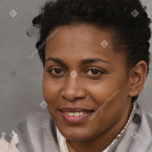 Joyful black young-adult female with short  brown hair and brown eyes