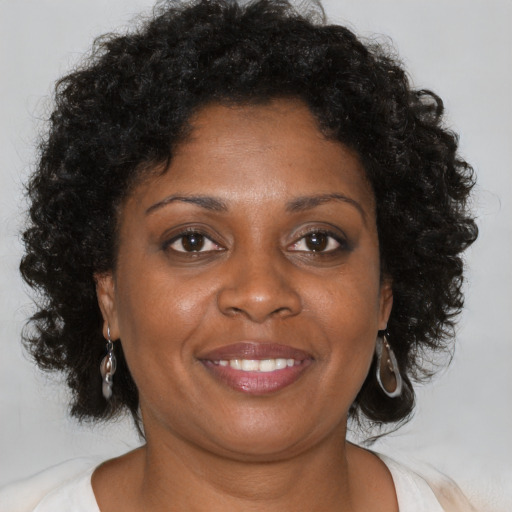 Joyful black young-adult female with medium  brown hair and brown eyes