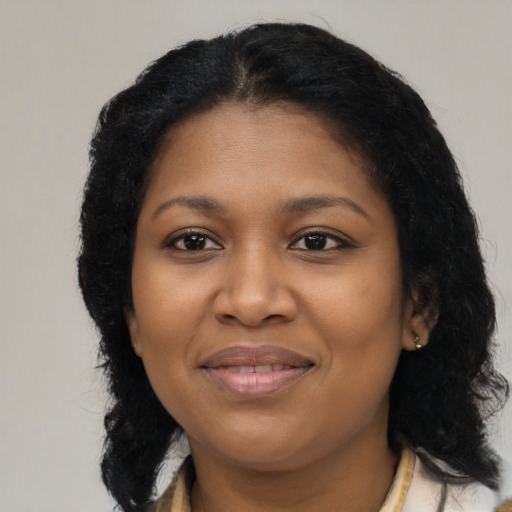 Joyful black young-adult female with medium  brown hair and brown eyes
