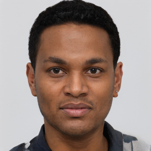 Joyful black young-adult male with short  black hair and brown eyes