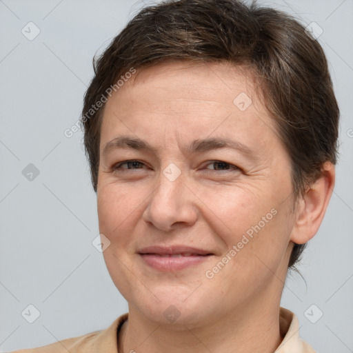 Joyful white adult female with short  brown hair and brown eyes