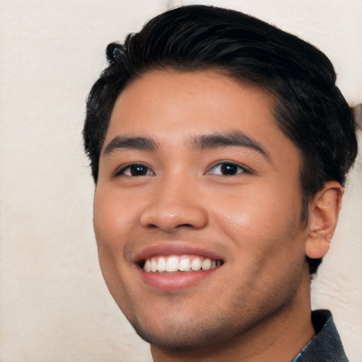 Joyful latino young-adult male with short  black hair and brown eyes