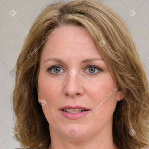 Joyful white adult female with medium  brown hair and blue eyes