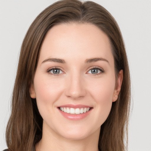 Joyful white young-adult female with long  brown hair and grey eyes