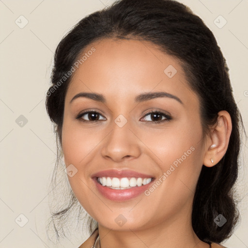 Joyful latino young-adult female with long  brown hair and brown eyes