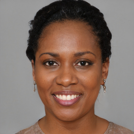 Joyful black young-adult female with short  black hair and brown eyes