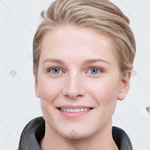 Joyful white young-adult female with short  brown hair and blue eyes