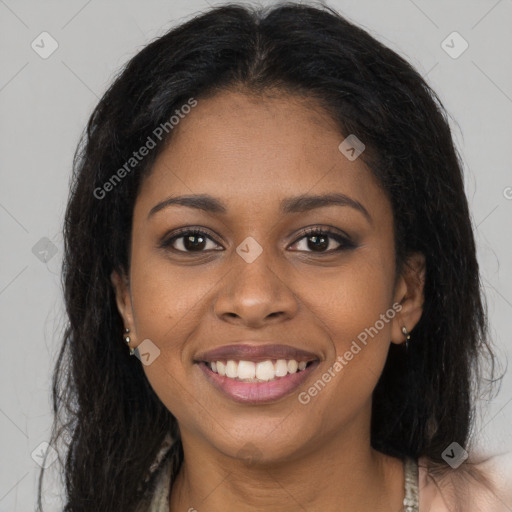 Joyful black young-adult female with long  brown hair and brown eyes