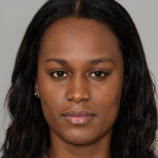Neutral black young-adult female with long  brown hair and brown eyes