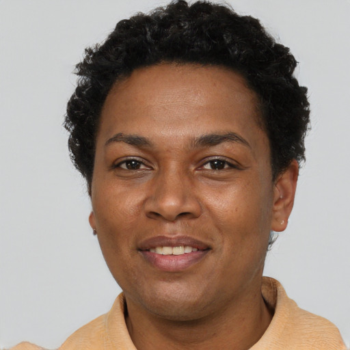 Joyful black adult female with short  brown hair and brown eyes