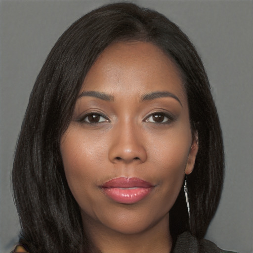 Joyful black young-adult female with long  brown hair and brown eyes