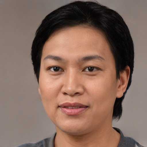 Joyful asian adult female with short  black hair and brown eyes