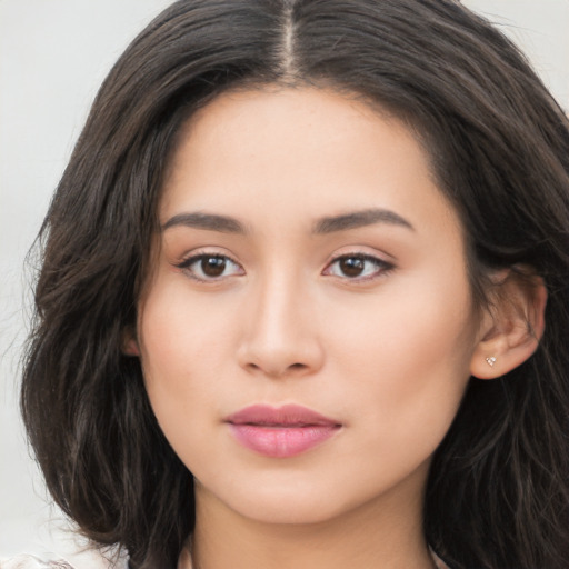 Joyful asian young-adult female with long  brown hair and brown eyes