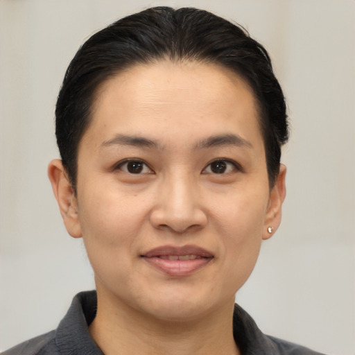 Joyful asian young-adult female with short  black hair and brown eyes