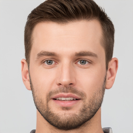 Joyful white young-adult male with short  brown hair and brown eyes