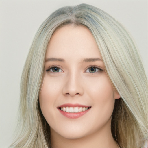 Joyful white young-adult female with long  brown hair and green eyes