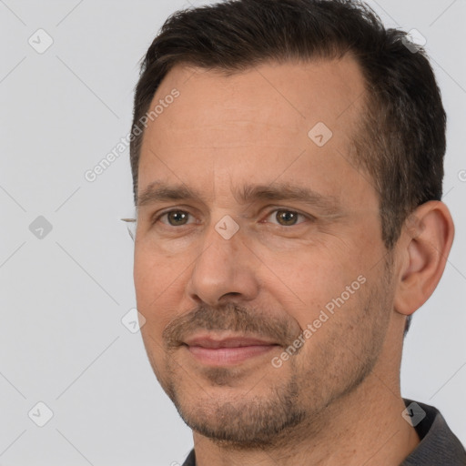 Joyful white adult male with short  brown hair and brown eyes