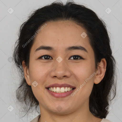 Joyful latino young-adult female with medium  brown hair and brown eyes