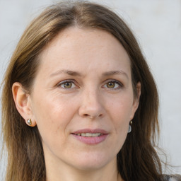 Joyful white adult female with long  brown hair and grey eyes