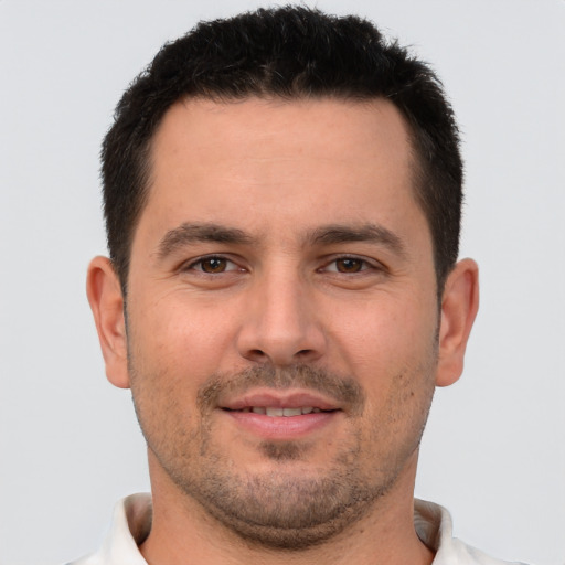 Joyful white young-adult male with short  brown hair and brown eyes