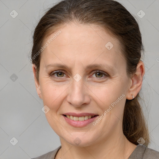 Joyful white adult female with medium  brown hair and grey eyes