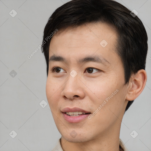 Joyful white young-adult male with short  black hair and brown eyes