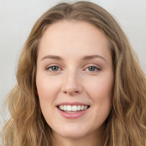 Joyful white young-adult female with long  brown hair and green eyes