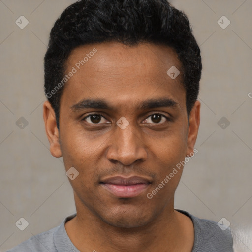 Joyful black young-adult male with short  black hair and brown eyes