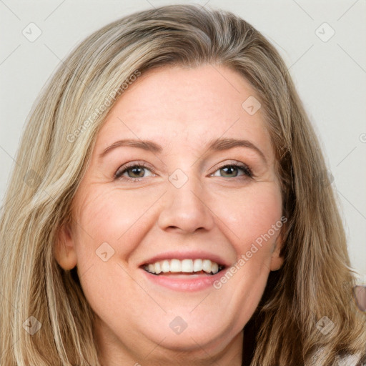 Joyful white adult female with long  brown hair and green eyes