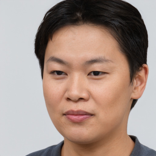 Joyful asian young-adult female with short  brown hair and brown eyes