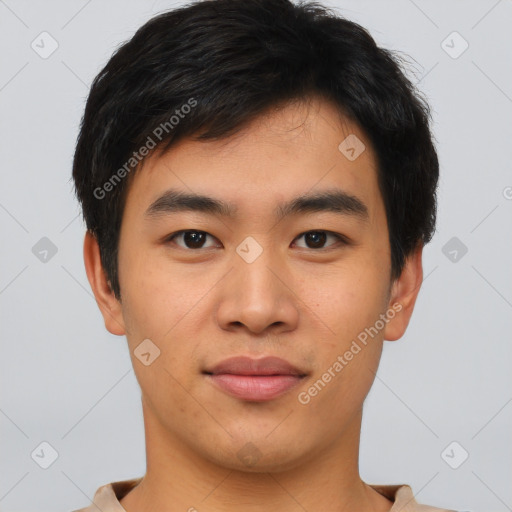 Joyful asian young-adult male with short  brown hair and brown eyes