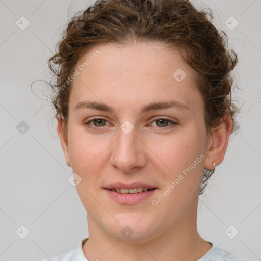 Joyful white young-adult female with medium  brown hair and green eyes