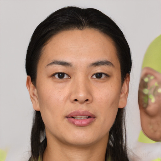 Joyful asian young-adult female with medium  black hair and brown eyes