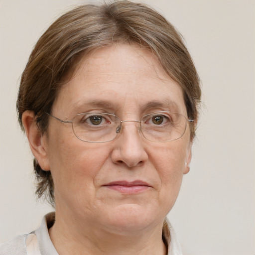 Joyful white middle-aged female with medium  brown hair and grey eyes