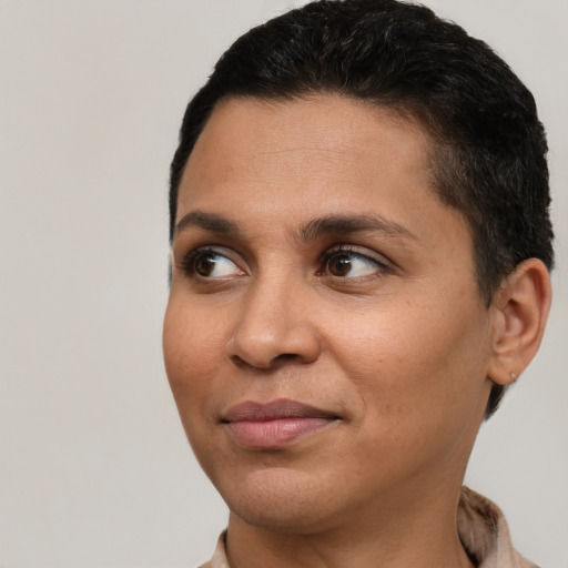 Joyful latino young-adult female with short  black hair and brown eyes