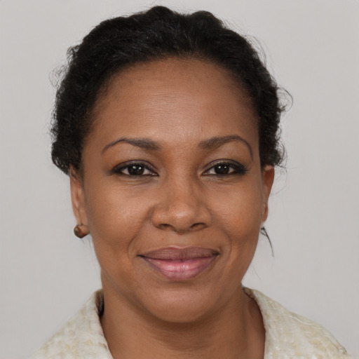 Joyful black adult female with short  brown hair and brown eyes