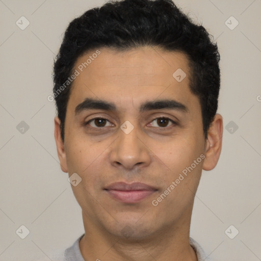 Joyful latino young-adult male with short  black hair and brown eyes