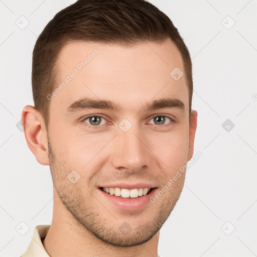 Joyful white young-adult male with short  brown hair and grey eyes