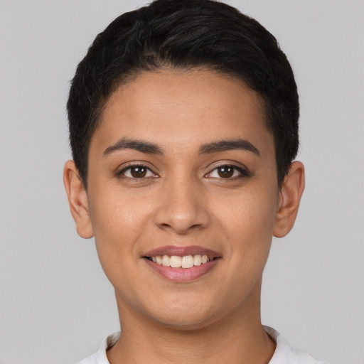 Joyful latino young-adult female with short  black hair and brown eyes