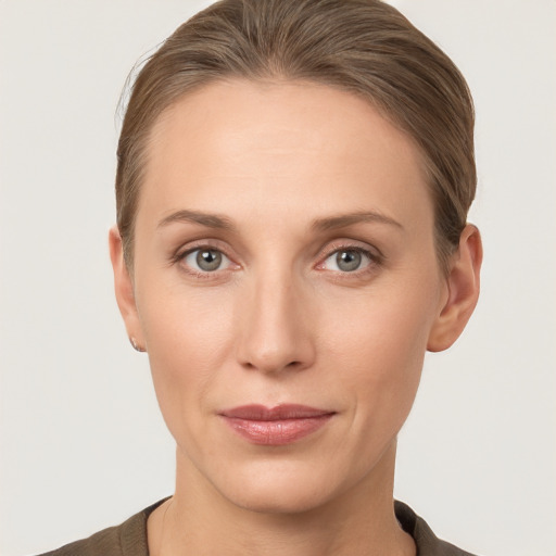 Joyful white young-adult female with short  brown hair and grey eyes