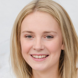 Joyful white young-adult female with long  brown hair and blue eyes