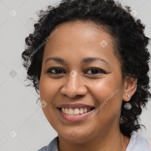 Joyful black young-adult female with long  brown hair and brown eyes