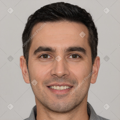 Joyful white young-adult male with short  black hair and brown eyes