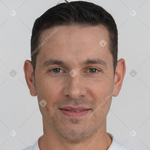 Joyful white adult male with short  brown hair and brown eyes