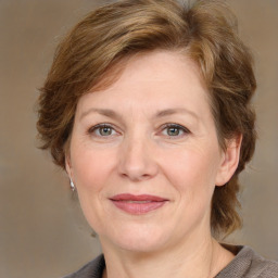 Joyful white adult female with medium  brown hair and grey eyes