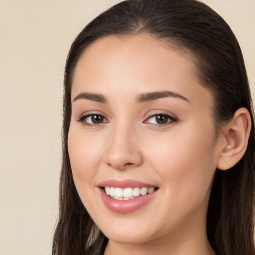 Joyful white young-adult female with long  brown hair and brown eyes