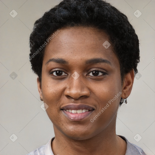 Joyful black young-adult female with short  black hair and brown eyes