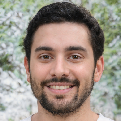 Joyful white young-adult male with short  black hair and brown eyes